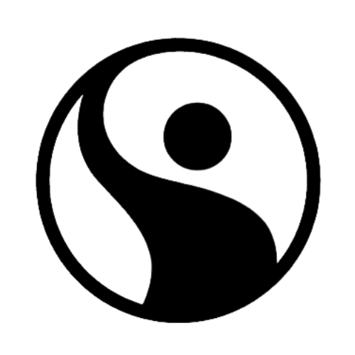 A scenic view of mountains under a clear blue sky, with lush green forests in the foreground.